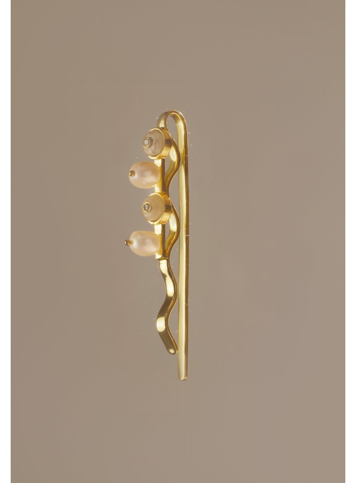 Horquilla dorada con piedras blancas