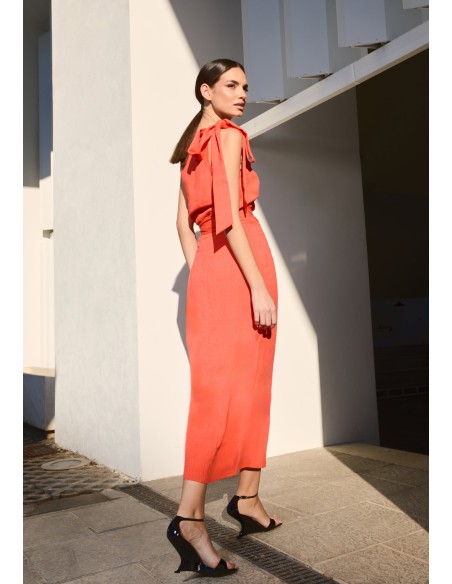 Orange asymmetrical top with lacing on the shoulder