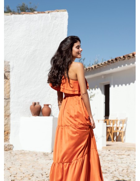 Long orange dress with ruffles and asymmetrical neckline