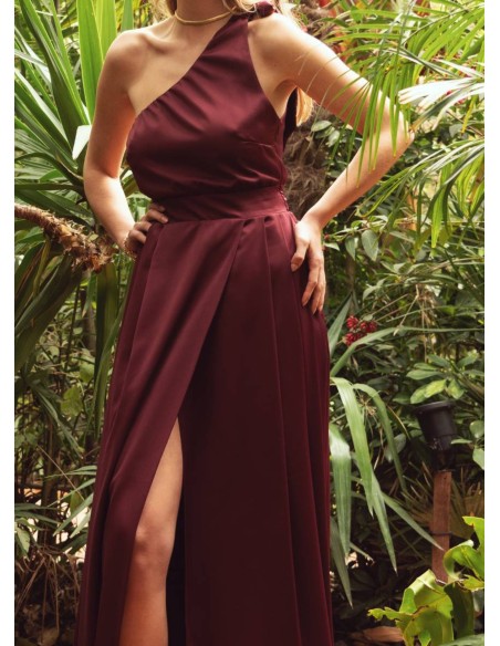 Long burgundy dress with asymmetrical neckline and opening skirt
