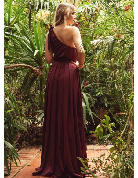 Long burgundy dress with asymmetrical neckline and opening skirt