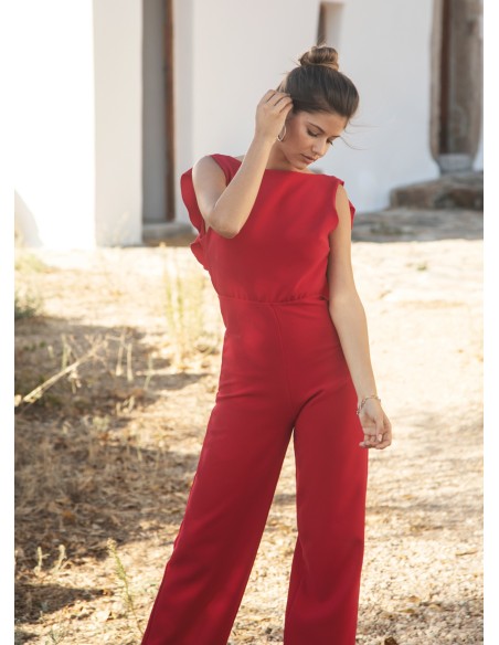 Long red jumpsuit with closed neckline and ruffle at the back