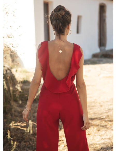 Long red jumpsuit with closed neckline and ruffle at the back