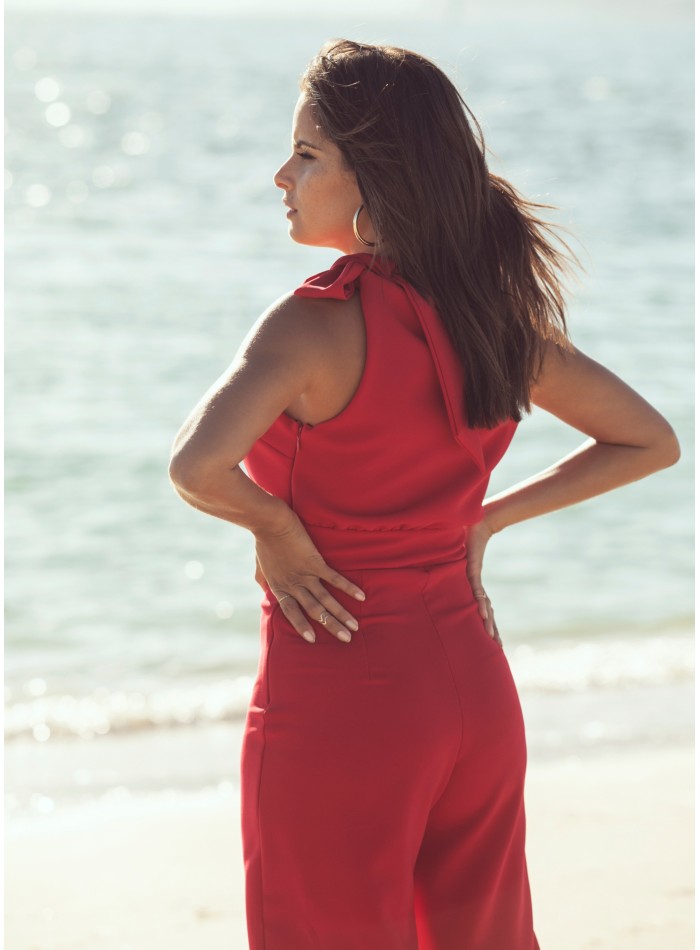 Asymmetrical red jumpsuit with lacing at the...