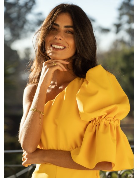 Yellow long jumpsuit with asymmetrical neckline and puffed sleeves