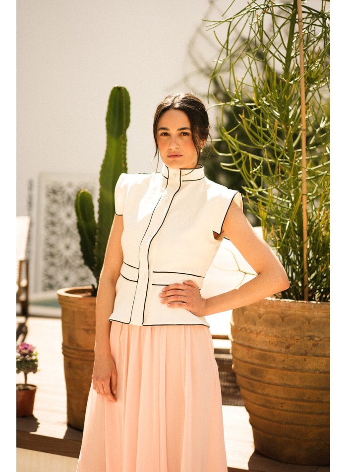 Ecru vest with black piping