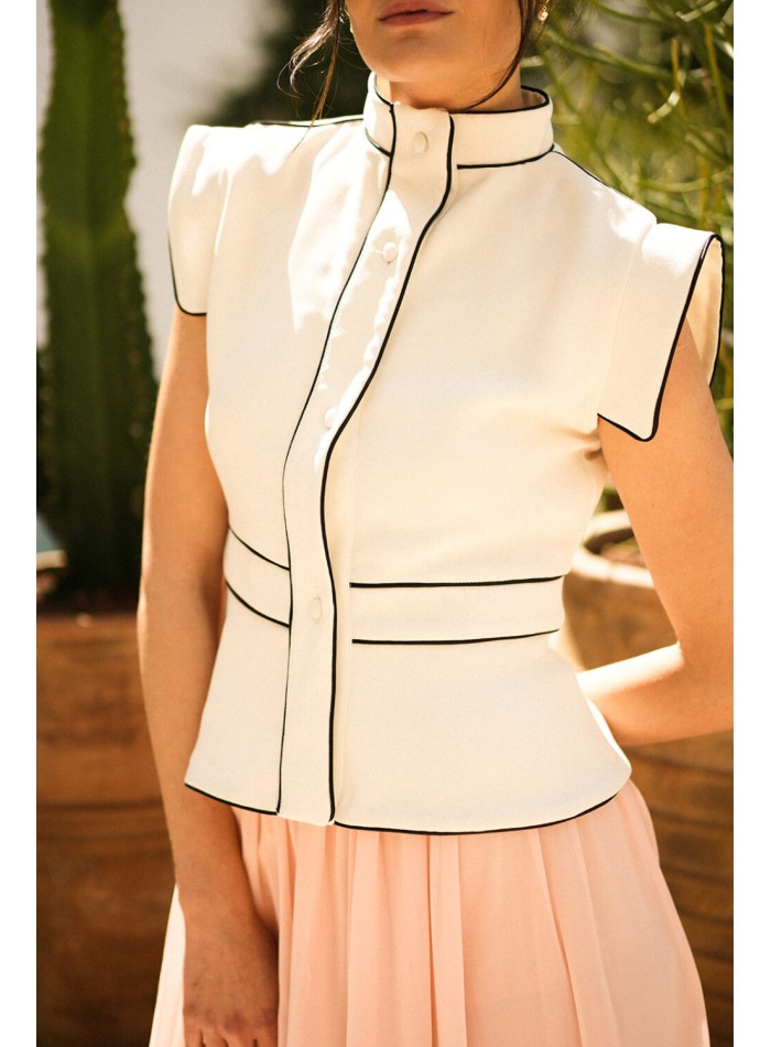 Ecru vest with black piping