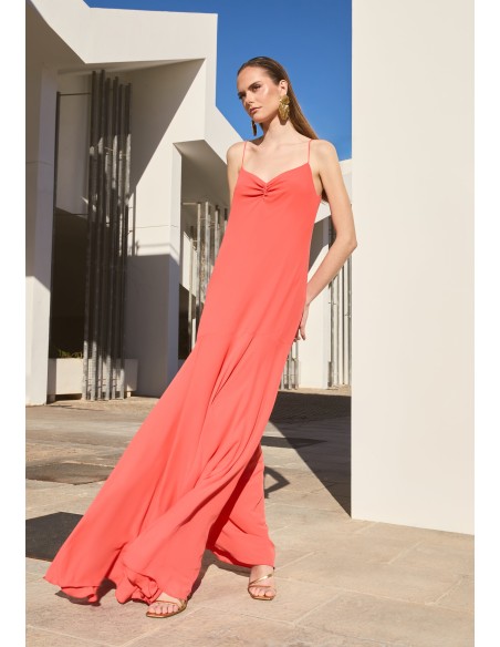 Long orange dress with ruffled neckline and cape skirt