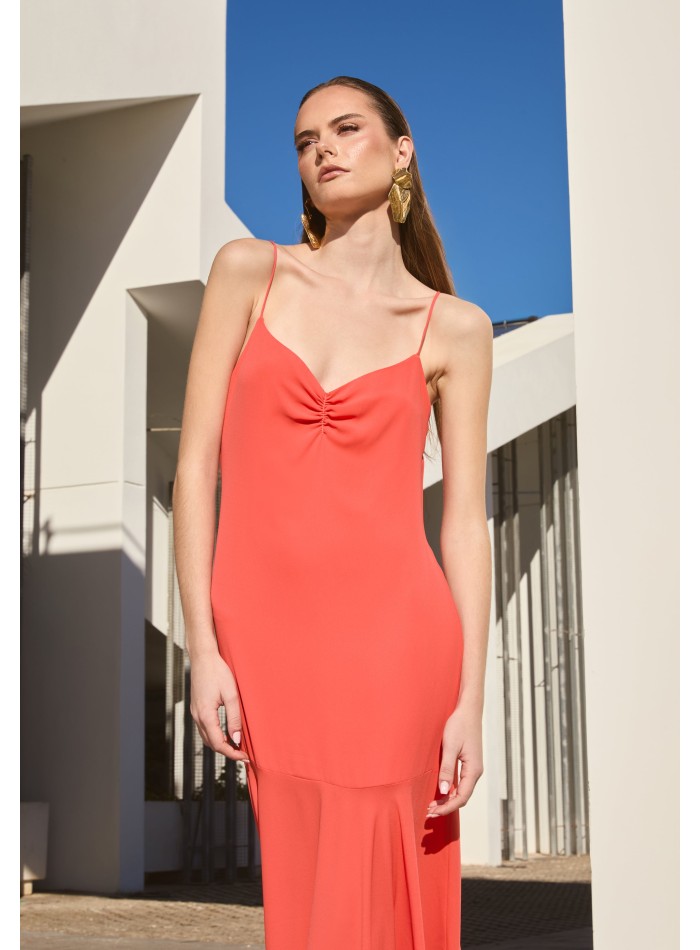 Long orange dress with ruffled neckline and...
