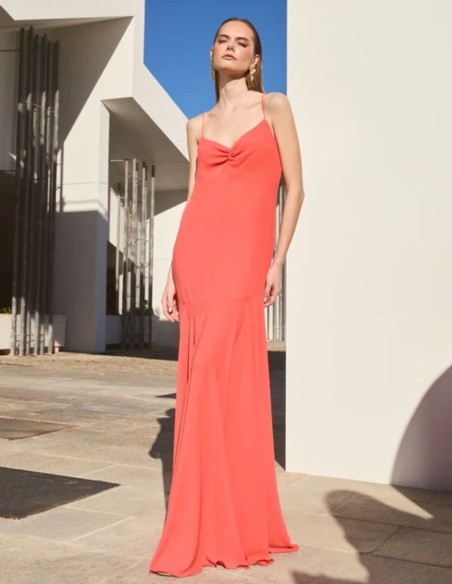 Long orange dress with ruffled neckline and cape skirt