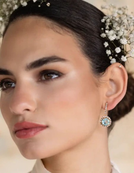 Earrings with aquamarine stone surrounded by zircons