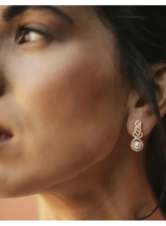 Earrings with intertwined zircons and central...