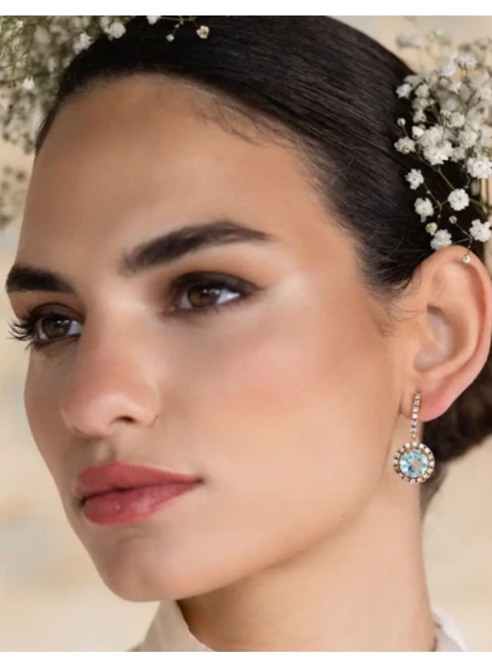 Earrings with faceted central stone surrounded...