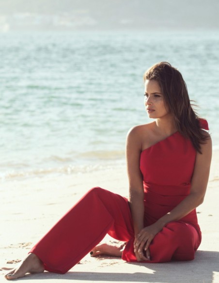 Asymmetrical red jumpsuit with lacing at the shoulder