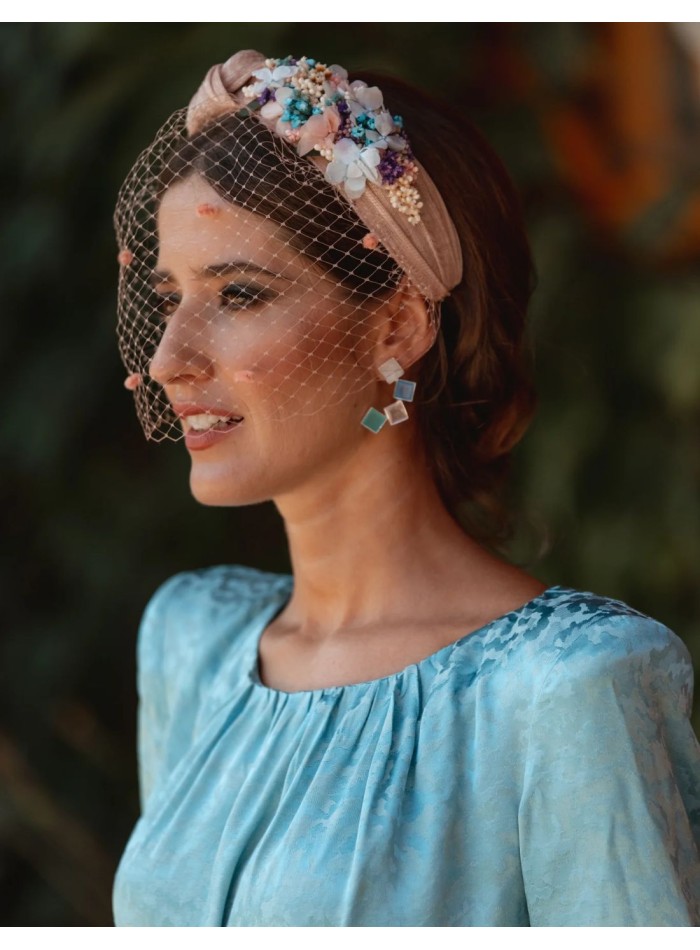 Diadema para invitada con flores y nudo en sinamay en tonos rosas