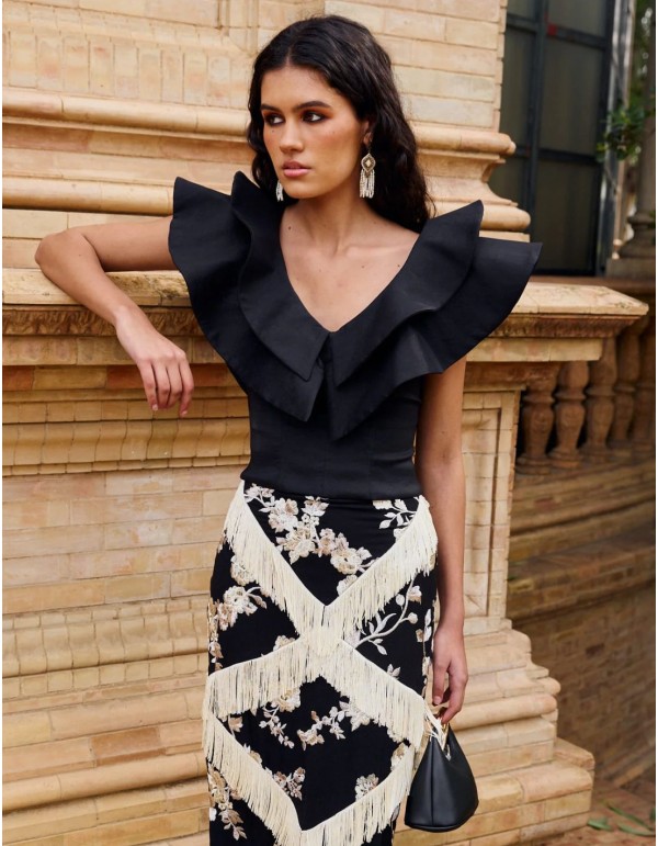 Black top with double ruffle V-neckline for guests