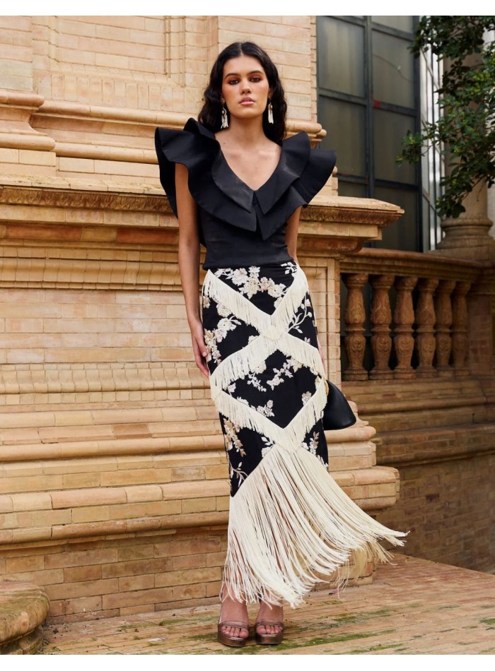 Black top with double ruffle V-neckline for guests