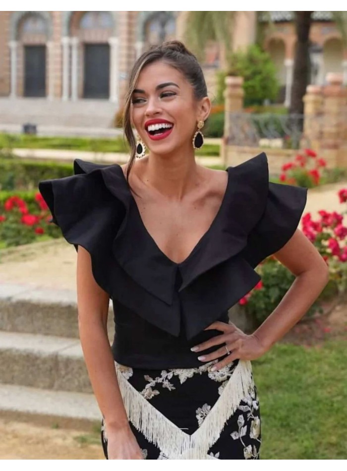 Black top with double ruffle V-neckline for guests