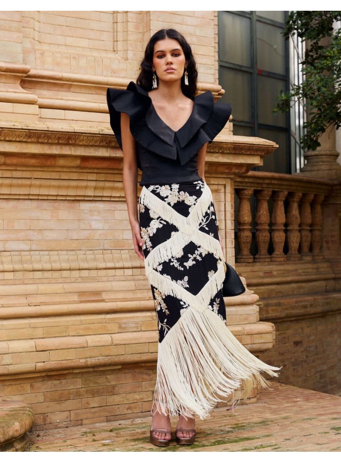 Falda midi negra con bordado floral y flecos en...