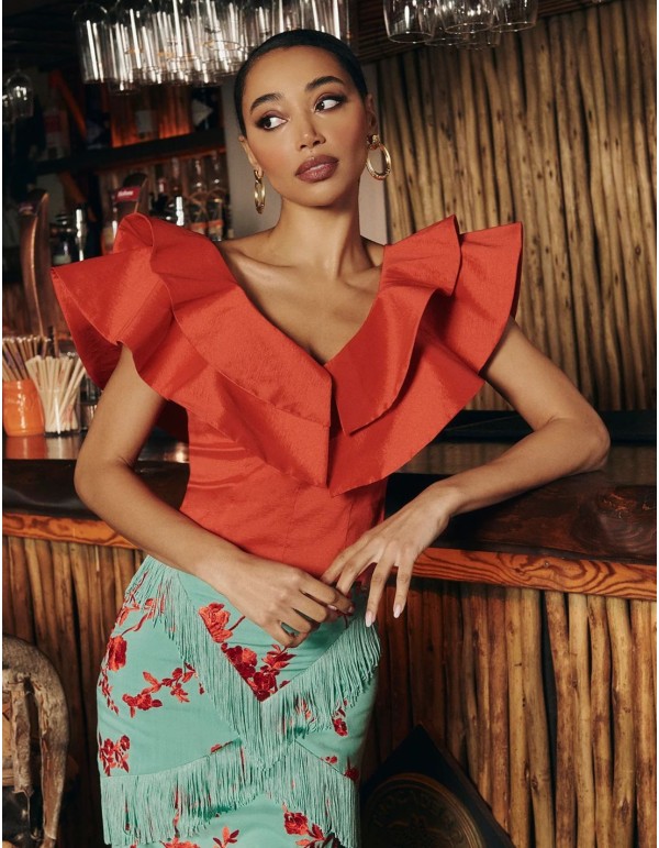 Red taffeta top with ruffles at the neckline for guests