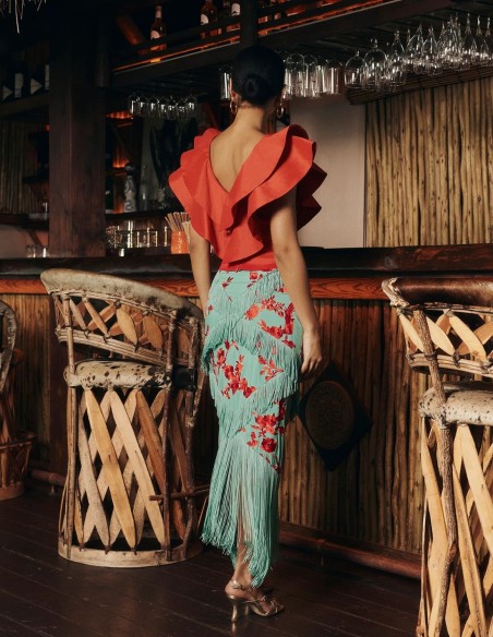 Red taffeta top with ruffles at the neckline for guests