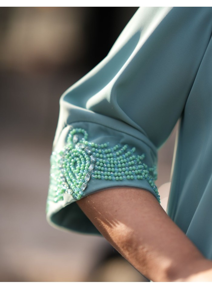 Two-piece set in aqua green with rhinestones on...