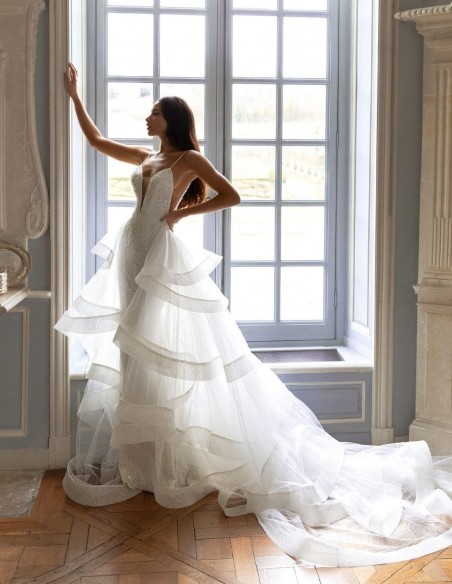 Wedding dress with a plunging V-neckline and detachable tail from Pollardi