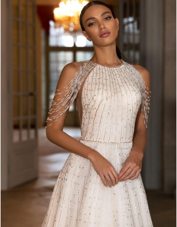 Wedding dress with fallen rhinestone shoulders  at INVITADISIMA 2