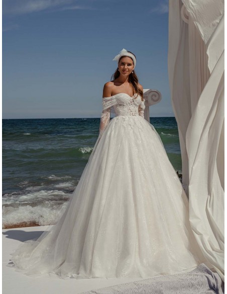 Princess cut wedding dress with wrap-around neckline and long sleeves in delicate lace by ANNIE VICTOR at INVITADISIMA