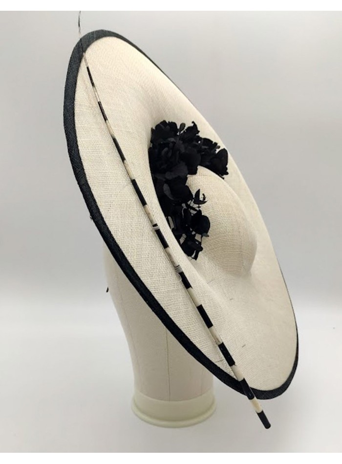 Headdress with a sinamay base decorated with preserved hydrangea branches.