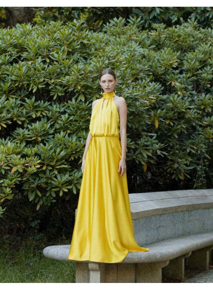 Long yellow dress with halter neckline and...