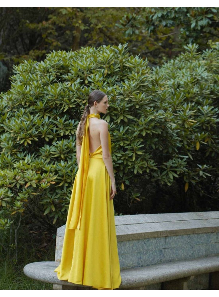 Long yellow dress with halter neckline and...