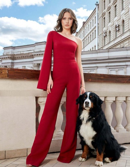 Red long party jumpsuit with asymmetric neckline and long caped sleeve for guests