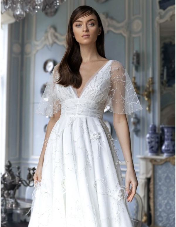 Wedding dress with sheer short sleeves and flowing skirt