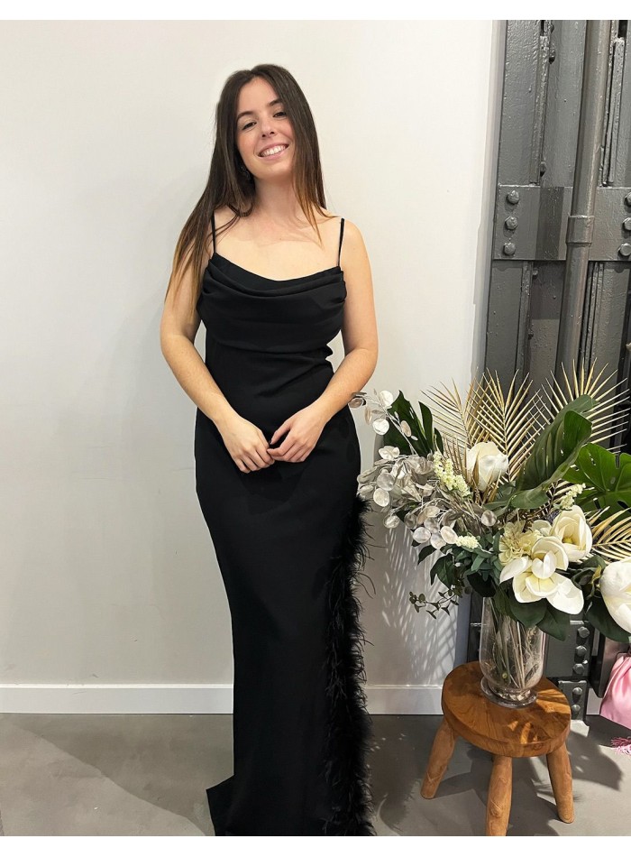 Long party dress with feathers in the opening.