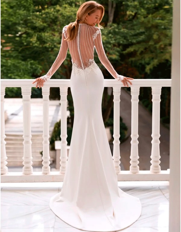 vestido de novia con espalda infinita con transparencias y manga de encaje con pedrería 2