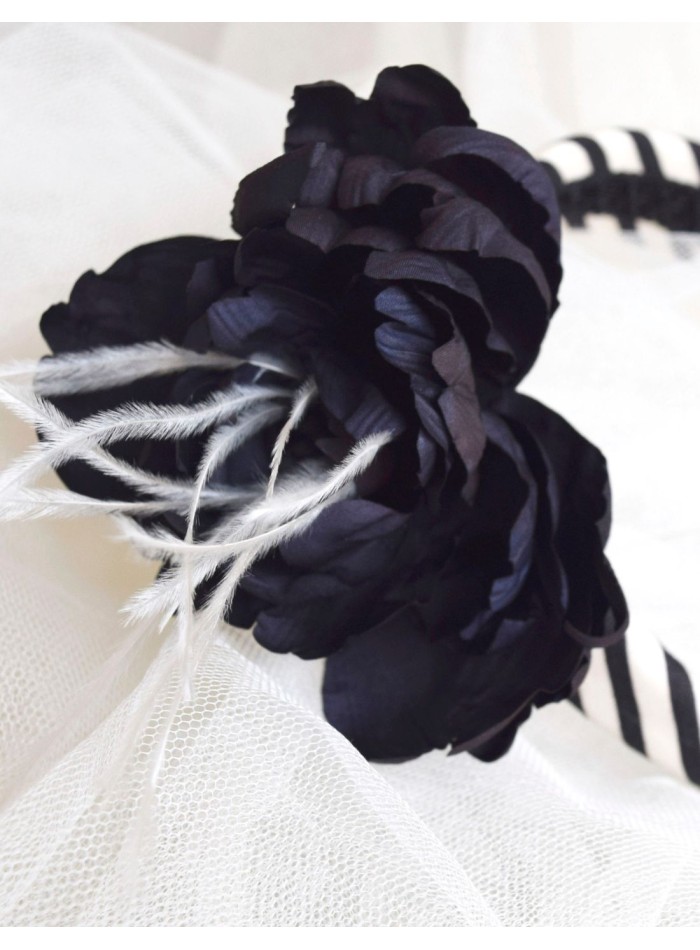 Striped headband with black flower appliqué...