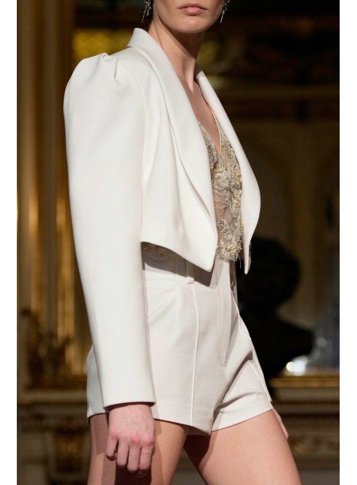 Short white blazer with long sleeves and...