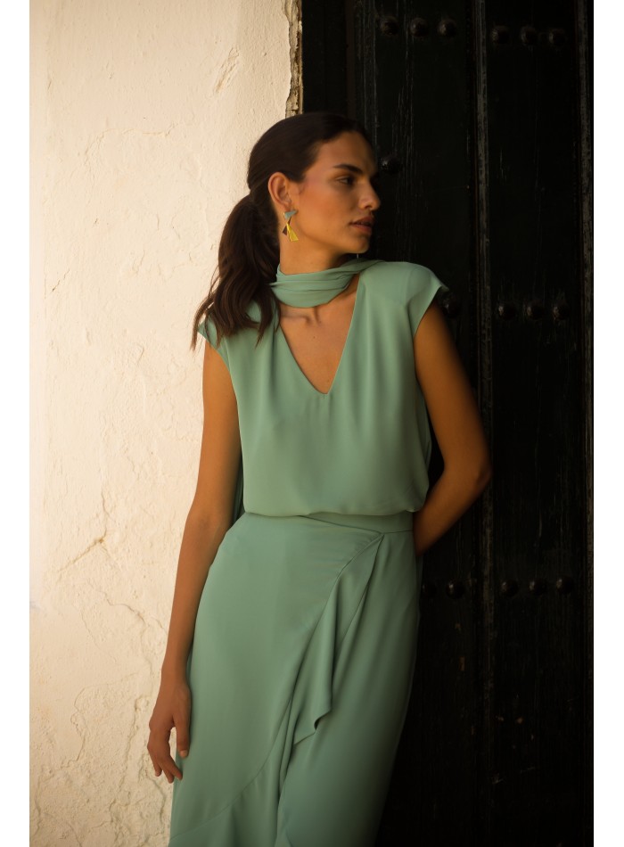 Top and skirt set with aqua green flouncy cross...