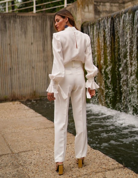 White blouse with long sleeves and ruffled details